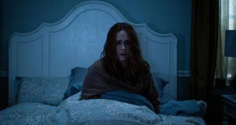 Sarah Paulson sits upright in bed in a dark room in Hulu’s Run