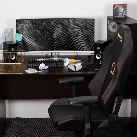 Secretlab Omega gaming chair in front of a cluttered desk