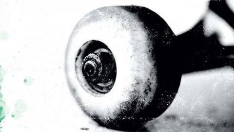 A close-up shot of a skateboard wheel, key art for the original Skate