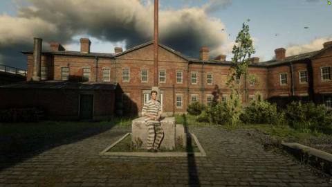 Red Dead Online - a player in a striped prison uniform poses in front of the in-game prison Siskia Penitentiary. 