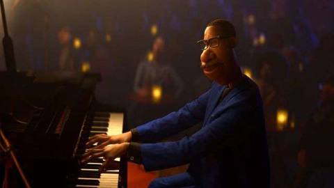 Soul protagonist Joe Gardner plays piano in a darkened room