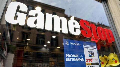 a photo of a GameStop window in Rome with a PS4 Slim promo