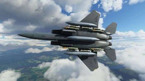 A fully-armed F-15 banks right over a marshy area on a clear day in Microsoft Flight Simulator.