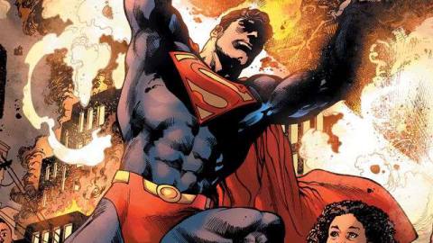 Superman lifts wreckages amid flames in a comic book panel