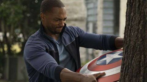 Falcon (Anthony Mackie) struggles to pull Captain America’s shield out of a tree it’s embedded in in Falcon and the Winter Soldier