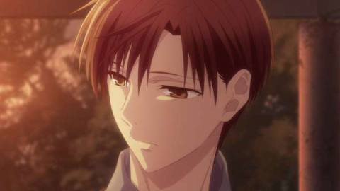 kureno from fruits basket, a man with light brown hair, looking forlorn in golden swathed lighting