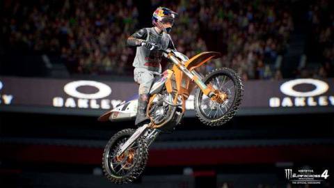 a rider takes a huge jump with the arena’s mezzanine video board in the background in Monster Energy Supercross 4