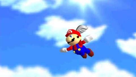 Mario flies against a cloudy blue sky in a screenshot from Super Mario 64
