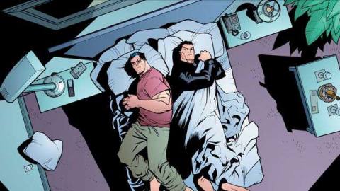 Clark Kent and Bruce Wayne grumpily share a single bed in a cruise ship room. Clark wears lounge pants and a tee shirt, Bruce has a leather jacket on an is hogging the covers, in Superman/Batman Annual #1, DC Comics (2006). 