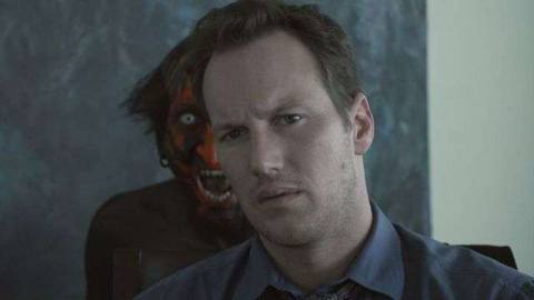A red-faced demon tauntingly scowls over the shoulder of Josh Lambert (Patrick Wilson) in James Wan’s Insidious
