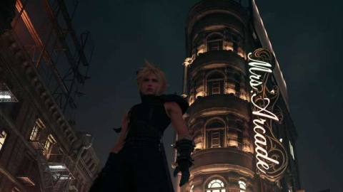 Cloud from Final Fantasy 7 Remake, standing in front of an ornate Beaux-Arts building in Sector 8.