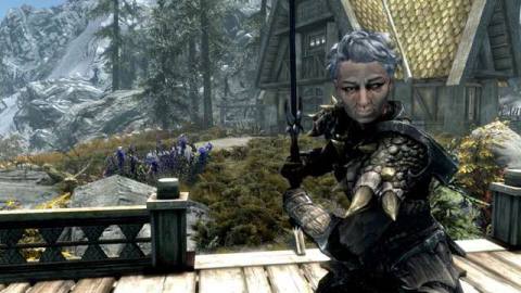 A shot of a character from Skyrim. She has grey hair and dragon armor.