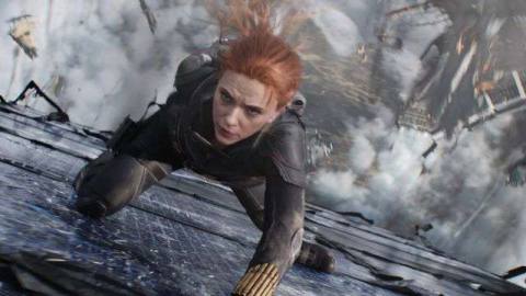 Black Widow slides her way down falling debris mid-air in the Marvel Studios film Black Widow.