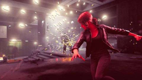 Control protagonist Jesse stands in front of a burst of sparks