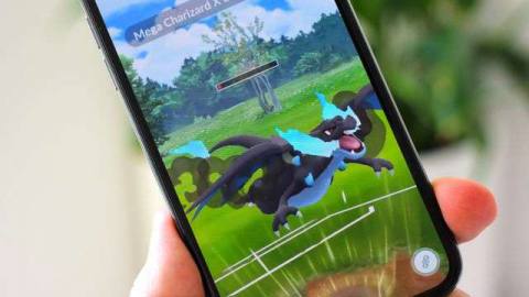 A photo of an iPhone displaying a Mega Charizard from Pokémon Go