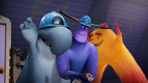 three monsters wearing hardhats and huddling in a celebratory stance. the one on the left resembles a tapir, the middle one is purple with horns, the one of the right is an orange furry crescent 