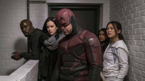 Luke Cage, jessica Jones, Daredevil, and Colleen Wing stand in the hallway in The Defenders