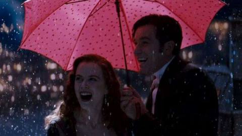 Nicole Kidman and Ewan McGregor under a pink umbrella in a shower of sparkles in Moulin Rouge