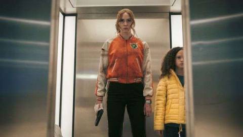 Karen Gillan as Sam and Chloe Coleman as Emily stand in an elevator in Gunpowder Milkshake