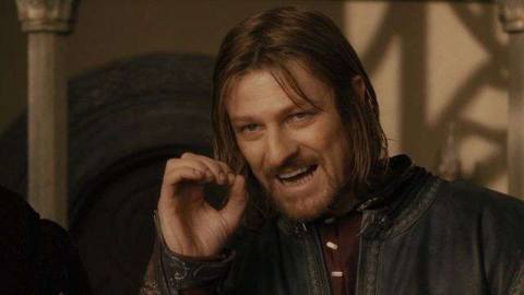 Boromir curls his hand into a circle as he speaks during the Council of Elrond in The Fellowship of the Ring.
