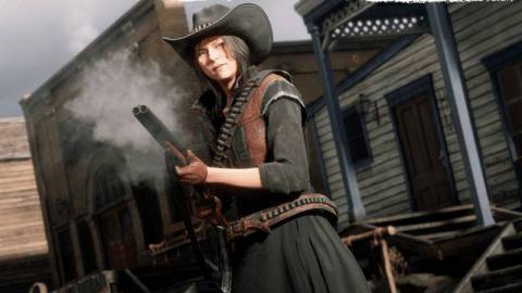 Red Dead Online - a young woman clutches a smoking shotgun. She’s dressed in red and black, with a cowboy hat and skirts on, and has black hair. She looks determined.