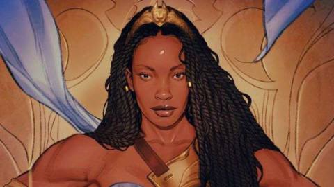 Queen Nubia of the Amazons in her blue and gold regalia, with waist-length locs and a golden circlet, on a variant cover for Nuba and the Amazons (2021). 