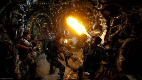 Colonial Marines use a flamethrower in a Xenomorph hive in Aliens: Fireteam.