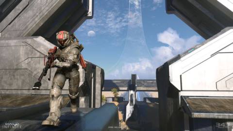 A Halo Infinite player runs forward with a sniper rifle