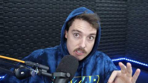 a screenshot of lazarbeam’s video. he is wearing a blue hoodie and is leaning close into the mic