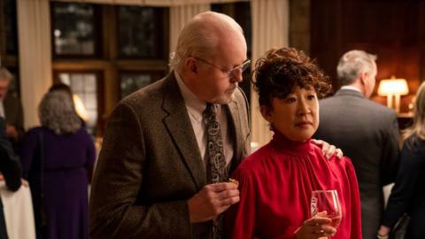 David Morse as the college dean puts his hand on Sandra Oh’s shoulder at an awkward faculty party in Netflix’s The Chair