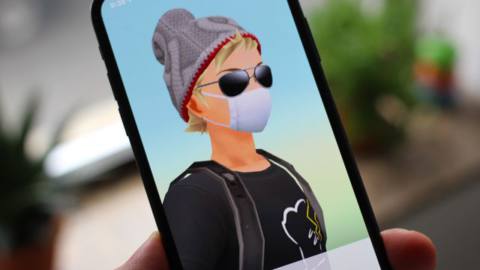 A trainer wears a white facemask in a photo of Pokémon Go on an iPhone