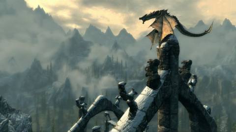 Skyrim - a dragon perched up on a castle spiral roars menacingly. In the distance are mountains and sky.