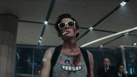 Mary Elizabeth Winstead, in sunglasses and a bloody Totoro shirt, in Netflix’s Kate