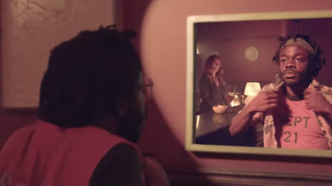 Demi Adejuyigbe looks in a mirror in his 9/21/21 video celebrating Earth, Wind &amp; Fire’s “September”