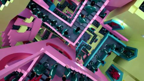 A vivid neon pink and green maze full of people, seen from the top down, in Squid Game