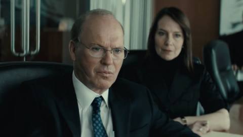Michael Keaton and Amy Ryan in a conference room grimacing in Worth