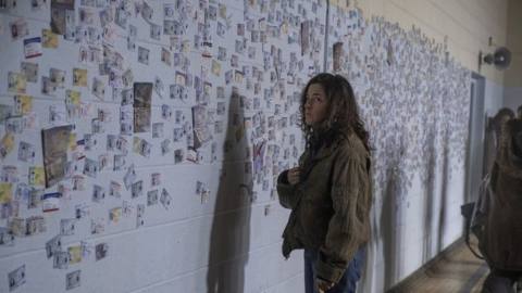 Hero Brown stands in front of a wall memorializing all the men who died in the FX on Hulu series Y: The Last Man.