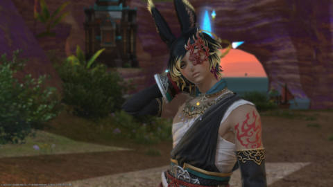 A male Viera in monk artifact gear stands in from of an Aetheryte