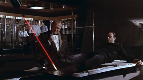 Scene from Goldfinger, the third James Bond film, in which Sean Connery is strapped to a slab of gold while a laser cutter threatens to bisect him through his crotch.