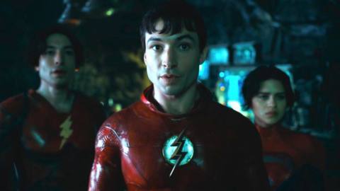 Ezra Miller as The Flash of two dimensions and the new Supergirl Sasha Calle stand in the batcave