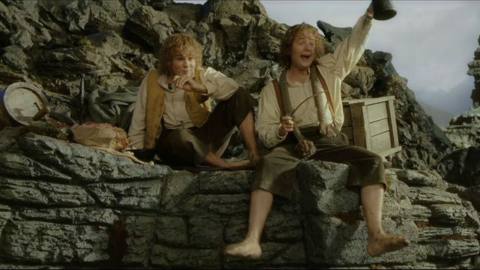 Merry and Pippin greet others excitedly in the wreckage of Isengard in The Return of the King.