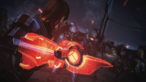 female Shepard fighting aliens with an Omni Blade in Mass Effect Legendary Edition