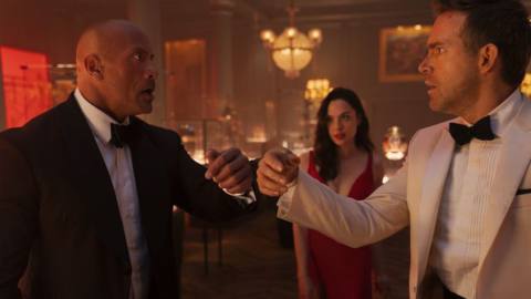 Dwayne Johnson, Gal Gadot, and Ryan Reynolds facing off in fancy dress in Red Notice
