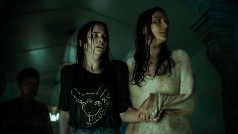 Hannah Cheramy and Catalina Sandino Moreno, looking wet and shaken, hang onto each other in the horror series From