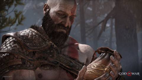 God of War (2018) on PC as Kratos holds a bag but looks sad
