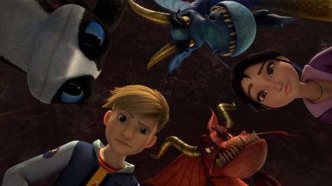 a blonde boy, a dark-haired girl, and three dragon faces looking down at something 