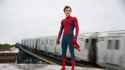 Spider-Man: Homecoming - a subway train goes by behind Spider-Man