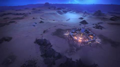 Dune Spice Wars - a city on Arrakis at night, with a few ships moving in the distance.