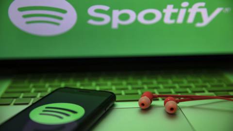 In this photo illustration the Spotify logo seen displayed...