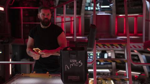 Amos standing in red light during season 6 of The Expanse
